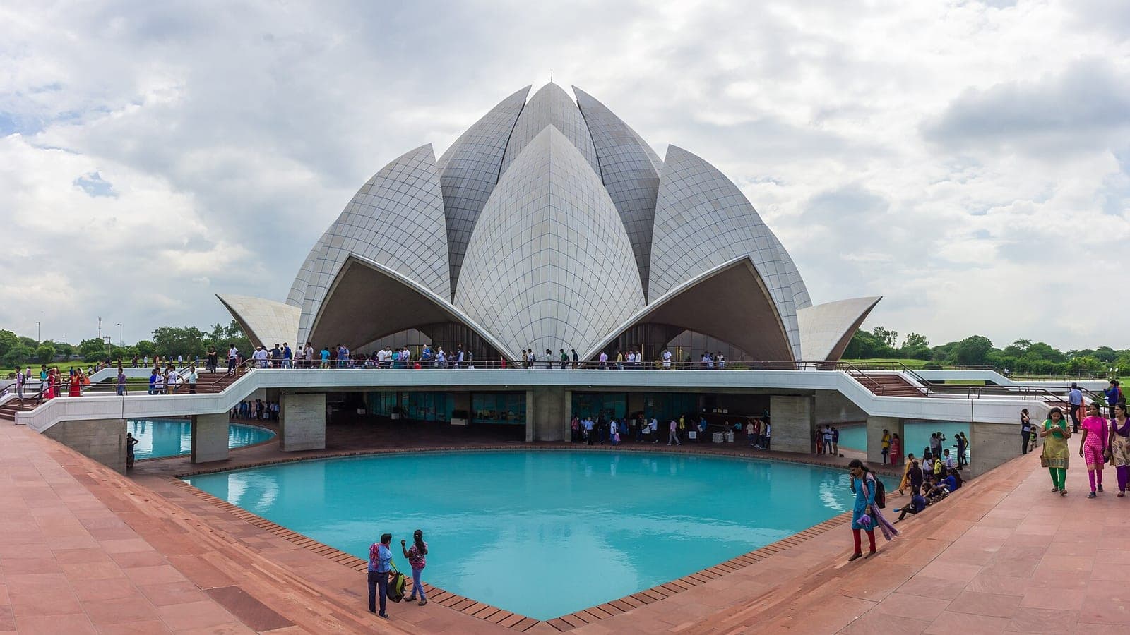 The Lotus Temple's marble petals above its reflecting pools, with visitors on the surrounding walkways.